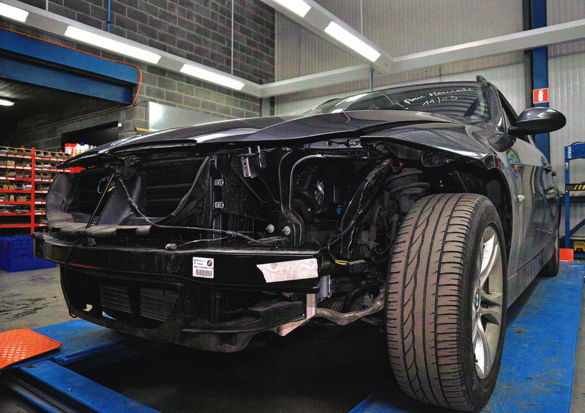 Een auto onder herstel in de werkplaats van Wonitrol — demontage in uitvoering.